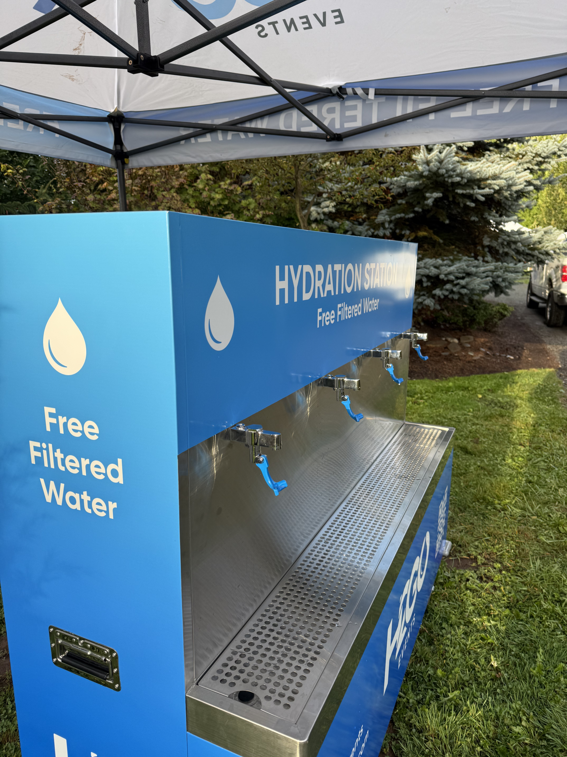 Blue H2GO water refill station under an outdoor canopy